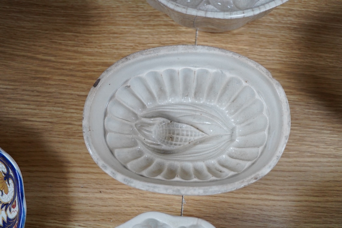 A collection of fifteen mostly 20th century ceramic jelly moulds, largest 16cm high